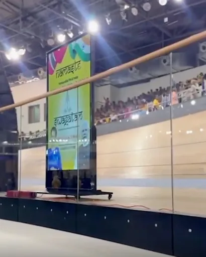 Timesquare vertical kiosk standing trackside inside the National Cycling Centre velodrome, Couva