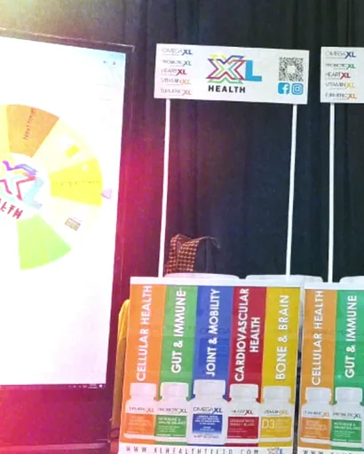 XL Health retail display with a spin-the-wheel screen, product stands and a pull-up banner